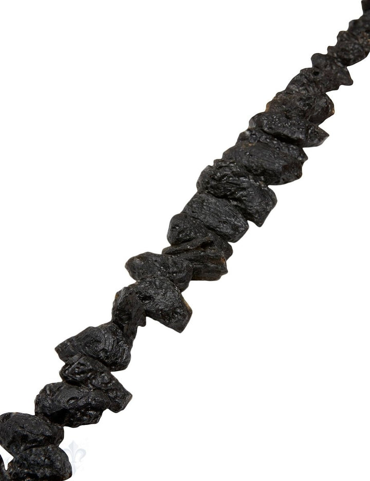Tektit Strang schwarz Trommelsteine Natur 28x18 mm quer AA (28-13 mm) im Verlauf - Shanti Enterprise AG